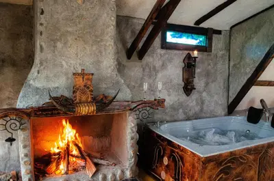 a bath room with a fireplace and a tub at Hoguera del Nómada in Santo Domingo