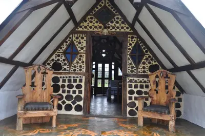 an entrance to a yurt with two wooden chairs at Hoguera del Nómada in Santo Domingo