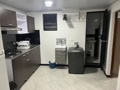 a kitchen with a trash can in the middle of it at Apartamento Dcastańo in Medellín
