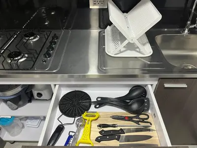 a kitchen drawer filled with kitchen utensils at Apartamento Dcastańo in Medellín