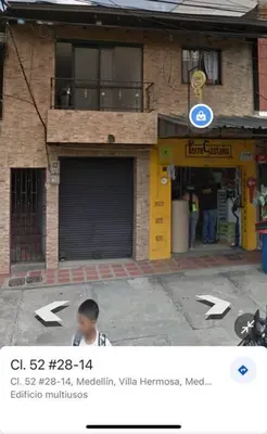 a boy is standing in front of a building at Apartamento Dcastańo in Medellín
