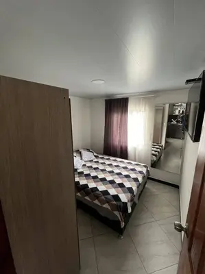 a bedroom with a bed in a room with a mirror at Apartamento Dcastańo in Medellín