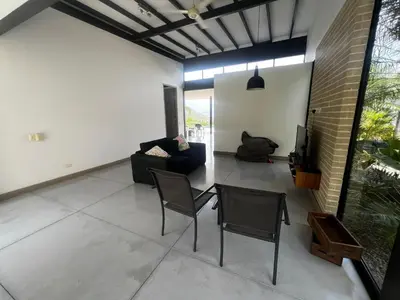 a living room with a couch and a table and chairs at Finca Los Polines en Tarso in Tarso