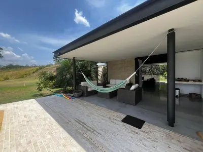 a hammock hanging from the roof of a house at Finca Los Polines en Tarso in Tarso