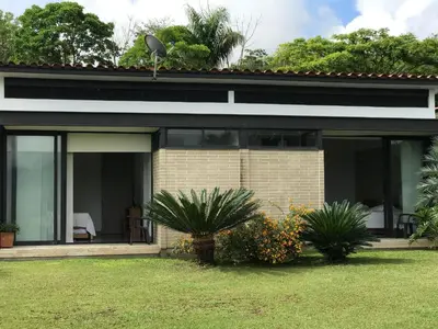 a house with large windows and plants in a yard at Finca Los Polines en Tarso in Tarso