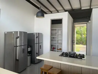 a kitchen with stainless steel refrigerators and a counter at Finca Los Polines en Tarso in Tarso