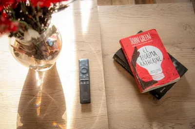a book sitting on a table next to a wine glass at loft grupo y parejas AZUCENAS in Jardin