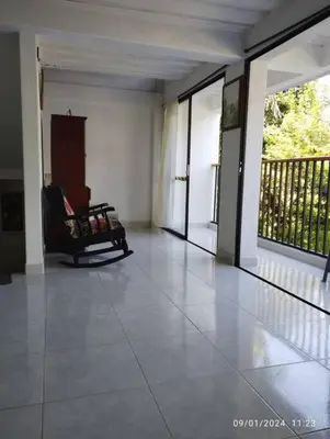 a living room with a chair on a porch at Casa de descanso unifamiliar in Venecia