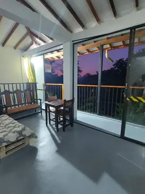 a room with a bed and a table and windows at Casa de descanso unifamiliar in Venecia