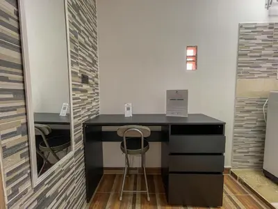a black desk with two stools in a room at Coliving Casa encanto, Apartamento - Habitaciones, Laureles-América in Medellín