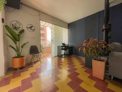 a living room with a checkered floor and plants at Coliving Casa encanto, Apartamento - Habitaciones, Laureles-América in Medellín