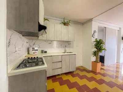 a kitchen with a sink and a stove top oven at Coliving Casa encanto, Apartamento - Habitaciones, Laureles-América in Medellín