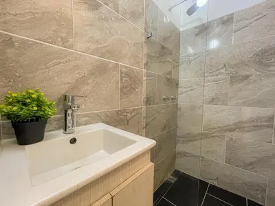 a bathroom with a sink and a shower at Coliving Casa encanto, Apartamento - Habitaciones, Laureles-América in Medellín