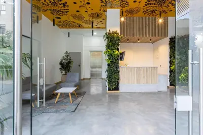 an office lobby with a yellow ceiling at Confortable Aparta Loft 903 Aiana Verde in Medellín