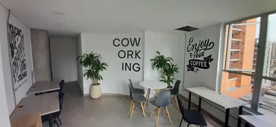 a dining room with a table and chairs and a window at Confortable Aparta Loft 903 Aiana Verde in Medellín