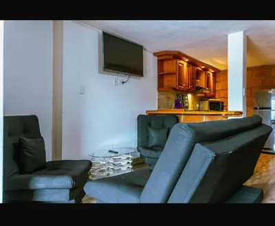 a living room with two couches and a table at Suite Doble Especial in Jericó