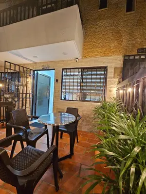 a room with chairs and a table and a table at Casa Hotel La Bonita in Medellín