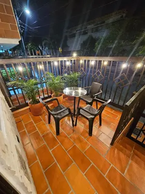 a balcony with a table and chairs and a table and chairs at Casa Hotel La Bonita in Medellín