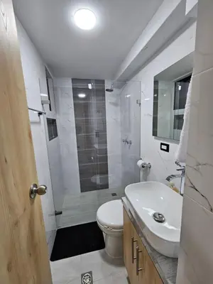 a bathroom with a shower and a toilet and a sink at Casa Hotel La Bonita in Medellín