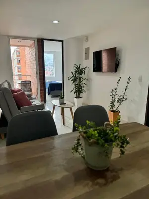 a living room with a table and chairs at Cómodo Apartamento Floresta -Estadio in Medellín