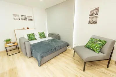 a bedroom with a bed and a chair at NEW! Homey Loft El Tesoro-Fast Wifi in Medellín