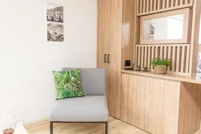a chair with a pillow on it in a room at NEW! Homey Loft El Tesoro-Fast Wifi in Medellín