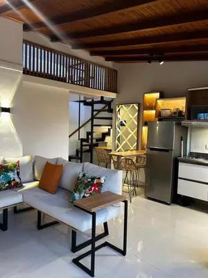 a living room with a couch and a kitchen at 'SELECT' Medellin in Medellín