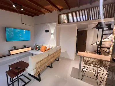 a living room with a couch and chairs and a tv at 'SELECT' Medellin in Medellín