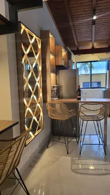 a kitchen with two chairs and a table and a counter at 'SELECT' Medellin in Medellín