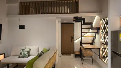 a living room with a couch and a staircase at 'SELECT' Medellin in Medellín