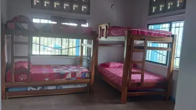 a room with two bunk beds and a small bed at Finca Villa Maria in La Pintada