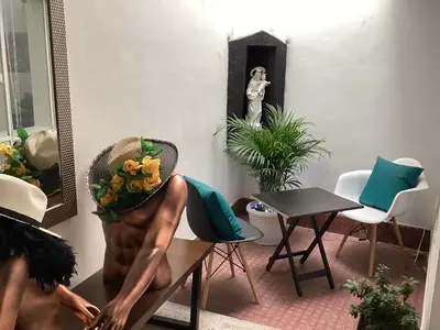a statue of a man sitting on a table in a room at Accommodation HOUSETEL COCOON Medellin in Medellín