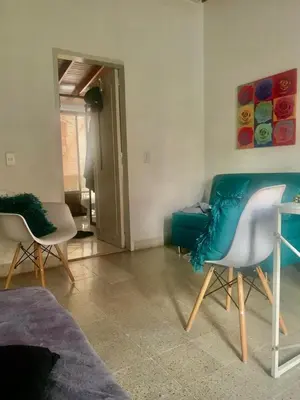 a living room with two chairs and a couch at Accommodation HOUSETEL COCOON Medellin in Medellín