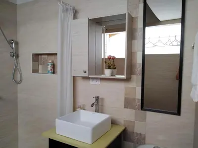 a bathroom with a white sink and a mirror at Mayorca Homestay in Medellín