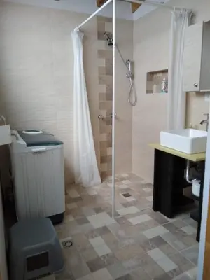 a bathroom with a shower and a toilet and a sink at Mayorca Homestay in Medellín
