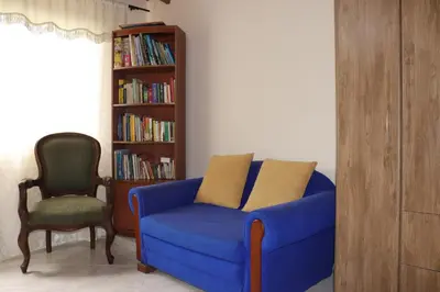 a blue couch and a chair in a living room at Mayorca Homestay in Medellín