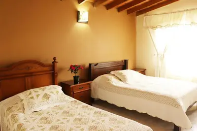 a bedroom with two beds and a window at Mayorca Homestay in Medellín