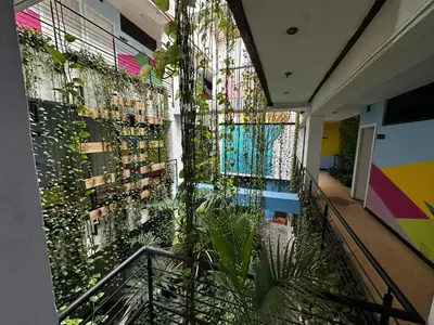 a hallway with plants on the wall of a building at Hotel Natural Medellin in Medellín