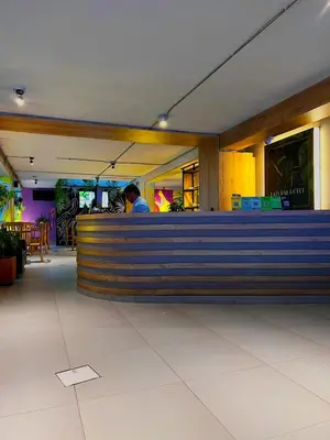 a man sitting at a bar in a restaurant at Hotel Natural Medellin in Medellín