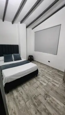 a bedroom with a bed and a projection screen at moderno y nuevo aparta estudio en Laureles in Medellín
