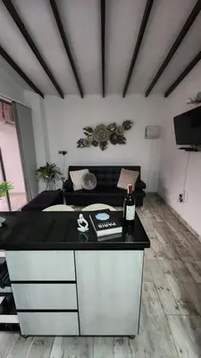 a room with a counter with a bottle of wine on it at moderno y nuevo aparta estudio en Laureles in Medellín