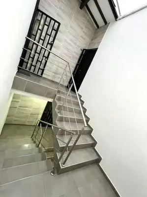 a staircase in a building with a metal railing at moderno y nuevo aparta estudio en Laureles in Medellín