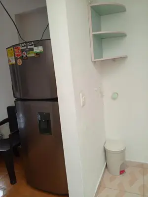 a refrigerator sitting in a kitchen next to a wall at usoinmobiliario in Medellín
