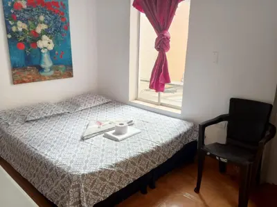 a small bedroom with a bed and a window at usoinmobiliario in Medellín