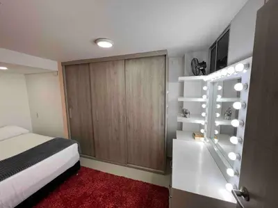 a bedroom with a bed and a bathroom with a tub at Apto 4 habitaciones privadas 140mtros in Medellín