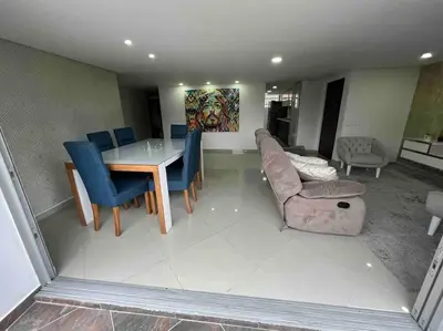 a living room with a table and blue chairs at Apto 4 habitaciones privadas 140mtros in Medellín