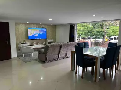 a living room with a couch and a table at Apto 4 habitaciones privadas 140mtros in Medellín