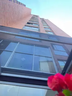 a tall building with a window on the side of it at El Poblado acomodación familiar hasta 6 personas in Medellín