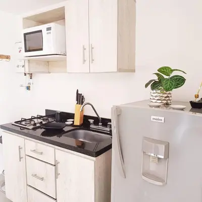 a kitchen with a sink and a microwave at El Poblado acomodación familiar hasta 6 personas in Medellín