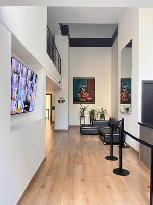 a living room with a couch and a tv on a wall at El Poblado acomodación familiar hasta 6 personas in Medellín